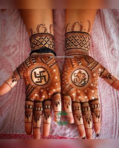 two hands with henna designs on them