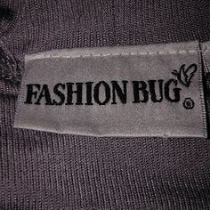 a label on the back of a sweater that says fashion bug