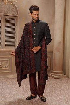 Black sherwani with all-over motifs, paired with maroon churidar. Comes with a dupatta with all-over resham and aari embroidery.
Component: 3
Embroidered
Neckline: Mandarin
Sleeve Length: Full
Fabric: Raw Silk
Color: Maroon, Black
Front button placket
Buttons on sleeve cuffs
Welt pocket
 - Aza Fashions Black Sherwani, Groom Sherwani, Embroidered Sherwani, Cape Jumpsuit, Aari Embroidery, Nehru Jackets, Embroidered Neckline, Indian Fashion Designers, Pernia Pop Up Shop