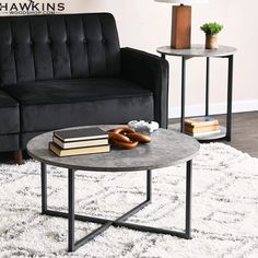 a living room with two black couches and a coffee table