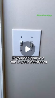 a white light switch sitting on the side of a wall next to a doorway with a video message