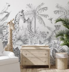 a baby's room with a wall mural and furniture