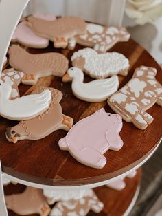 several decorated cookies sitting on top of a wooden table