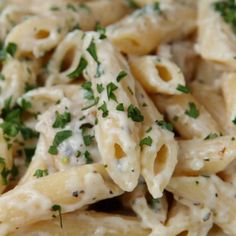 pasta with chicken and parsley in a white sauce