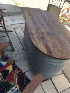 a wooden table sitting on top of a tiled floor