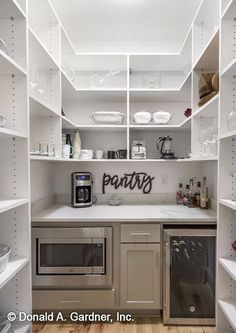 a kitchen with white shelving and stainless steel appliances