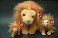 a stuffed lion with two smaller ones sitting next to it