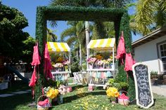 an outdoor area decorated with flowers and umbrellas