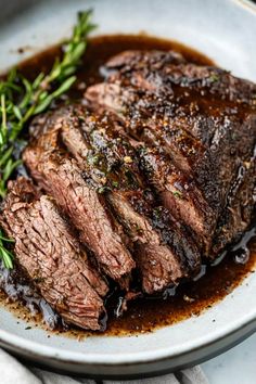 steak with gravy on a white plate