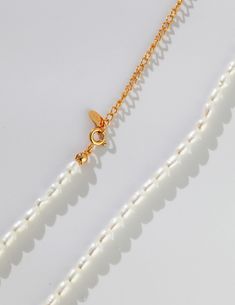 Discover the Timeless Beauty of our Delicate Pearl Choker in Gold The Simple Pearl Choker with Gold Chain by Señorita J is a beautiful example of elegance and simplicity. This choker is perfect for people who appreciate subtle and refined things, and it features a string of glossy pearls, each one ranging between 3mm and 3.5mm, giving it a classic charm and grace. The gold details on this choker are delicate and understated, which complements the pure beauty of the pearls without overpowering th Classic White Pearl Choker Necklace, White Pearl Choker With Delicate Chain, Classic White Chain Necklace With Pearl Charm, Classic Pearl Pendant Choker Necklace, Classic Pearl Drop Choker Necklace, Minimalist Pearl Chain Necklace With Pearl Charm, Classic Pearl Necklace With Delicate Chain, White Minimalist Single Strand Chain Necklace, Minimalist White Single Strand Chain Necklace