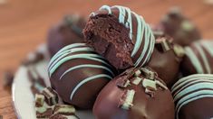 chocolate covered desserts on a plate with white frosting and chopped up candy bars