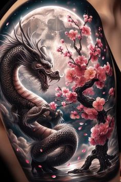 a woman's arm with a dragon and cherry blossom tree on it, in front of the moon