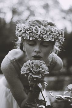 a woman with flowers in her hair and arabic writing on the cover of a book