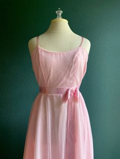 "This is the Barbie Dream Dress you have been looking for. 1960's  Vintage dress made by Dance Allure in Pink Swiss Dot fabric in the most Barbie Pink Color.  Spaghetti  Straps  Satin Bow at waist  Side zip closure  Floor Length Measurements laying flat: 17\" at bust  12.5 inches at high waist  open hip  from shoulder strap to hem 60\"" Pink Daywear Dresses With Bow, 1950s Style Pink Daywear Dresses, Barbie Pink Color, Vintage Fashion 1960s, Swiss Dot Fabric, 1960 Dress, Fashion 1960s, Pink Gown, Pink Gowns