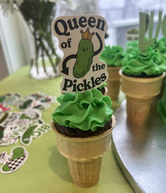 cupcakes in ice cream cones with green frosting on top and the words queen of the pickles