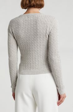 A cozy layering piece, this cable-knit sweater is knit from supersoft cashmere in a contemporary cropped silhouette. 20 1/2" length (size Small) Crewneck Long sleeves 100% cashmere Dry clean Imported Cable Knit Merino Wool Cardigan, Merino Wool Cable Knit Cardigan For Layering, Fitted Cashmere Cozy Sweater, Fitted Cozy Cashmere Sweater, Cozy Fitted Cashmere Sweater, Long Sleeve Cashmere Cable Knit Top, Chic Cable Knit Cashmere Sweater, Long Sleeve Cable Knit Cashmere Top, Cable Knit Cashmere Long Sleeve Top