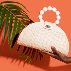 Inspired by the minaudière bags of the 1930s - an era when bags were seen as decorative and ornamental, THE ISABELLA is brimming with character. Crafted by our artisans in the Philippines, the structured semi-circle bag is made from T’nalak fabric with an iconic Solihiya rattan weave overlay. You’ll find a brass twist lock clasp to open this beauty, whilst the interior reveals a drawstring opening. Featuring a wooden beaded top handle, the bag also comes with a detachablecrossbody strap - perfec Rattan Weave, Unique Handbags, Woven Handbags, Rattan Bag, Beaded Top, Resort Style, Woven Bag, Perfect Bag, The Philippines