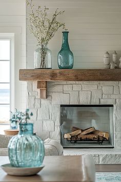 a living room with a fire place and vases on the mantle