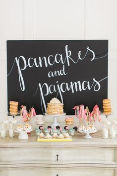 the dessert table is set up with cookies and pastries on it, along with a sign that says pancakes and pajema's