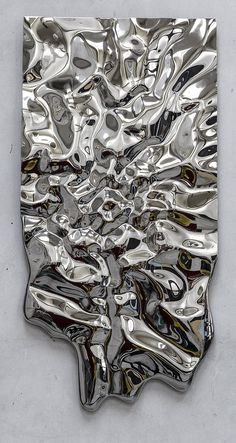 an abstract metal sculpture is shown on the wall