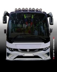 the front end of a white bus with lights on it's hood and windshield