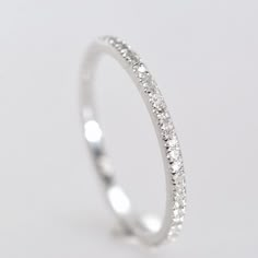 a white gold wedding band with small diamonds