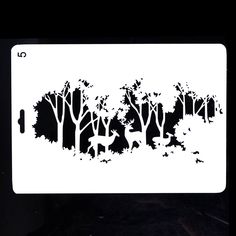 a white license plate with trees and birds in the woods on it's side