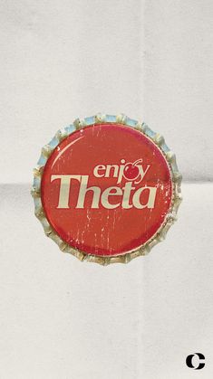 a bottle cap that says enjoy thea on it is hanging from a white wall