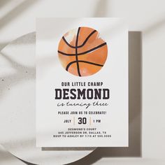 a basketball themed birthday party card on a white plate with a shadow from the paper