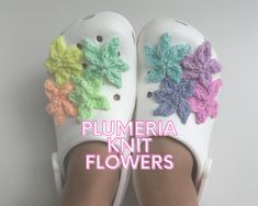 a pair of white shoes with colorful crochet flowers on the front and bottom