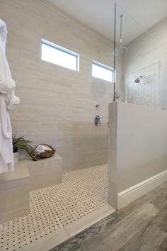 a bathroom with a walk in shower next to a sink