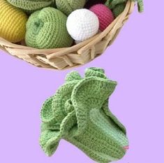 a basket full of crocheted balls and mittens on a purple background with the same item in it