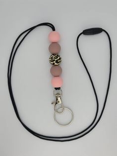 Soft pink, fawn, and leopard print breakaway beaded lanyard made with 15mm round food grade silicone beads. Beaded lanyards can be used to hold keys, ID badge, driver's license, cards, etc. Perfect gift for teachers, Mother's Day, Christmas, Birthday, or for anyone who loves beautifully beaded lanyards. Measures about 21 inches hanging. Round Food, Car Charms Mirror, Beaded Lanyard, Teacher Lanyard, Beaded Lanyards, Wristlet Keychain, Beaded Keychains, Id Badge Holders, Beaded Accessories