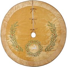 a round piece of wood with an embroidered wreath on it