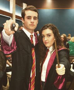 a man and woman dressed in harry potter costumes