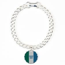 a silver bracelet with a blue heart and words on the clasp, that says i love you to the moon and back