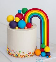 a rainbow cake with sprinkles and decorations