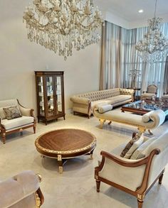 a living room filled with furniture and a chandelier