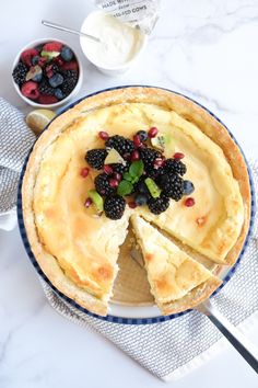 a pie with fruit on top is sitting on a table