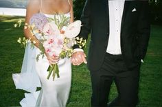 the bride and groom are holding hands