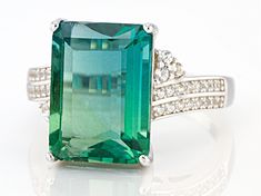 Pre-Owned 8.20ct emerald cut teal fluorite with .28ctw round white zircon, rhodium over sterling silver bypass ring. Measures approximately .84"L x .59"W. Not sizeable..  This product may be a customer return, vendor sample, or on-air display and is not in its originally manufactured condition.  It may not be new.  In some instances, these items are repackaged by JTV. Formal Emerald Gemstones With Accents, Formal Emerald Cut Green Topaz Ring, Modern Emerald Jewelry With Accent Stones, Formal Fine Jewelry Topaz Ring For May Birthstone, Formal May Birthstone Topaz Ring, Formal Green Topaz Ring With Accent Stones, Formal Green Topaz Gemstone Ring, Extravagant Jewelry, Bypass Ring