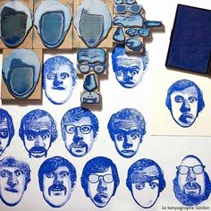 some blue and white images are being used to make rubber stamps on the paper,