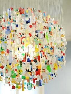 a chandelier made out of glass bottles and other items hanging from the ceiling