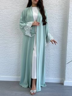 Expertly crafted for a modest yet stylish look, this two-piece Abaya in mint green features a delicate lace design on its sleeves and comes with a chic belt for a flattering fit. Elevate your wardrobe with this elegant and versatile piece.      Size info   True to size.   Ask Anything about the fit and Sizing.      Details & care   Be the belle of every ball (or prom, or homecoming) Achieve elegant and effortless style with our New In Two Piece Abaya. Made with a delicate mint green chiffon fabr Two Piece Abaya, Luxury Abaya, Chic Belt, Deep Neckline, Fabric Gift Bags, Lace Design, Chiffon Fabric, Print Gifts, Effortless Style