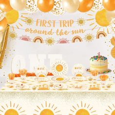 a first trip around the sun themed birthday party with balloons and desserts on a table