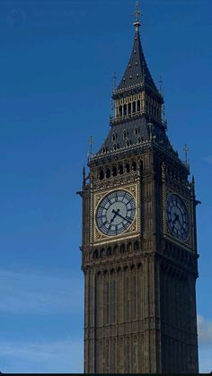 the big ben clock tower towering over the city of london on a clear blue day