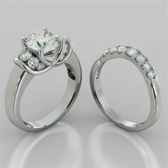 two engagement rings with diamonds on each side and the center stone set in white gold