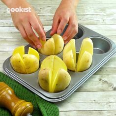 someone cutting up some potatoes in a muffin tin