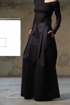 "Elevate your style and embrace the avant-garde with our Handmade Black Wide-Leg Skirt Pants, a true masterpiece for urban women who are fearless in their fashion choices. Crafted with precision and passion, these pants are designed to make a statement. They are made from high-quality cotton, ensuring both comfort and warmth during the colder months. The very wide leg construction, adorned with expertly tailored pleats, not only adds a dramatic flair but also allows for unrestricted movement. Fo Large Pants Outfit, Pants With Pleats, Cotton Palazzo Pants, Black Cotton Skirt, Womens Palazzo Pants, Wide Skirt, Wide Leg Palazzo Pants, Avant Garde Fashion, Organic Clothing