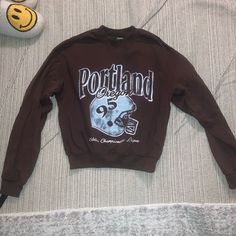 Perfect Length Cropped Sweatshirt! Worn Twice So Basically Brand New! Brown Long Sleeve Tops For College, Fall College Brown Tops, Brown Graphic Print Long Sleeve Sweatshirt, Brown Long Sleeve Sweatshirt With Graphic Print, Brown Sporty Sweater For Streetwear, Sporty Brown Sweater For Streetwear, Brown Graphic Print Sweatshirt For Streetwear, Brown Relaxed Fit Sweatshirt With Letter Print, Brown Cotton Sweatshirt With Letter Print